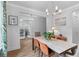 Bright dining room with modern chandelier, large windows, stylish chairs and attractive décor at 727 Hodge Rd, Summerville, SC 29483
