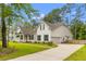 Beautifully designed two-story home with a manicured lawn, long driveway and attached garage at 727 Hodge Rd, Summerville, SC 29483