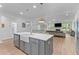 Bright open kitchen featuring a gray island, white cabinets, stainless appliances, and open floor plan at 727 Hodge Rd, Summerville, SC 29483