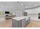 Bright open kitchen featuring a gray island, white cabinets, stainless appliances, and open floor plan at 727 Hodge Rd, Summerville, SC 29483
