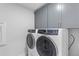 Modern laundry room with gray cabinetry, and stainless steel washer and dryer at 727 Hodge Rd, Summerville, SC 29483
