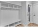 Mudroom with custom built-ins, seating, coat hooks, and storage cubbies, next to laundry room at 727 Hodge Rd, Summerville, SC 29483