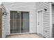 This back patio features a sliding glass door, a white back door, and exterior siding at 7813 Sandida Ct, North Charleston, SC 29418
