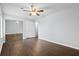 This bedroom features hardwood floors, a ceiling fan, a closet with mirrored doors, and a freshly painted wall at 7813 Sandida Ct, North Charleston, SC 29418