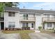 View of townhomes featuring balconies, trimmed bushes, and individual walkways at 7813 Sandida Ct, North Charleston, SC 29418