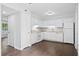 Bright eat-in kitchen featuring white cabinets, modern appliances, and hardwood flooring at 7813 Sandida Ct, North Charleston, SC 29418