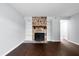 Open living room featuring a stone fireplace with built-in shelves and wood flooring at 7813 Sandida Ct, North Charleston, SC 29418