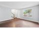 Bright living room featuring wood flooring, a large window, and a staircase at 7813 Sandida Ct, North Charleston, SC 29418