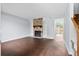Open living room featuring a stone fireplace with built-in shelves and wood flooring at 7813 Sandida Ct, North Charleston, SC 29418