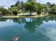 Community pond with pool and tree reflections offers a picturesque view for relaxation and enjoying outdoor amenities at 7813 Sandida Ct, North Charleston, SC 29418