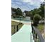 Community pool with a bridge and water features, surrounded by lush greenery, perfect for relaxation and recreation at 7813 Sandida Ct, North Charleston, SC 29418