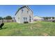 Spacious backyard featuring a concrete patio, outdoor seating, and well-maintained lawn, great for entertaining at 8038 Regency Elm Dr, North Charleston, SC 29406