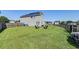 Wide fenced-in backyard featuring a well-maintained lawn and fire pit area with Adirondack chairs at 8038 Regency Elm Dr, North Charleston, SC 29406
