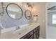 Elegant bathroom boasts double sinks, modern lighting, and an entrance to the bedroom at 8038 Regency Elm Dr, North Charleston, SC 29406