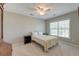 Cozy bedroom with neutral walls, ceiling fan, a comfy bed, and a view from the window at 8038 Regency Elm Dr, North Charleston, SC 29406