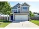 Charming two-story home with a well-manicured lawn and a welcoming blue front door at 8038 Regency Elm Dr, North Charleston, SC 29406