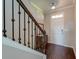 Inviting foyer with hardwood floors, a staircase, and an elegant chest adding character to the entrance at 8038 Regency Elm Dr, North Charleston, SC 29406