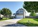 Attractive two-story home with well-maintained lawn, mature tree, and a two-car garage at 8038 Regency Elm Dr, North Charleston, SC 29406