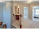 Upstairs hallway with wood railing overlooking the stairs, and access to the bedrooms and bathrooms at 8038 Regency Elm Dr, North Charleston, SC 29406