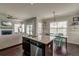 Bright kitchen with a center island featuring a sink and dishwasher, open to the living area at 8038 Regency Elm Dr, North Charleston, SC 29406