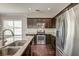 Modern kitchen features stainless steel appliances, dark wood cabinets, and granite countertops at 8038 Regency Elm Dr, North Charleston, SC 29406
