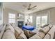Bright living room boasts a fireplace, and a large sectional sofa with access to outdoor space at 8038 Regency Elm Dr, North Charleston, SC 29406