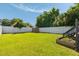 Spacious backyard features a white fence, a shed, lush lawn, and garden bed; perfect for outdoor activities at 814 Rutledge Ave, Charleston, SC 29403