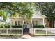 Beautiful home exterior boasting a welcoming front porch, tidy landscaping, and a charming picket fence at 814 Rutledge Ave, Charleston, SC 29403
