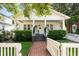 Inviting home exterior featuring a brick walkway, well-maintained lawn, and a classic covered porch at 814 Rutledge Ave, Charleston, SC 29403