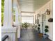 Relaxing front porch area with stylish lanterns, neutral furniture and decorative plants at 814 Rutledge Ave, Charleston, SC 29403
