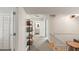 Hallway with view of staircase, carpeted floor, and open door to a bathroom at 814 Rutledge Ave, Charleston, SC 29403