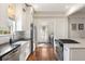 Modern kitchen featuring stainless steel appliances, farmhouse sink, and wood floors at 814 Rutledge Ave, Charleston, SC 29403