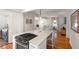 Open-concept kitchen island with quartz countertop and stainless steel range with laundry room view at 814 Rutledge Ave, Charleston, SC 29403