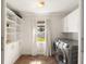 Well-lit laundry room with new washer and dryer, built-in storage, and a window at 814 Rutledge Ave, Charleston, SC 29403