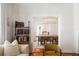 Open-concept living area showcasing hardwood floors, a decorative shelving unit, and bright lighting at 814 Rutledge Ave, Charleston, SC 29403
