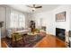 Cozy living room with hardwood floors, a decorative fireplace, and ample natural light at 814 Rutledge Ave, Charleston, SC 29403