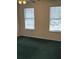 A bedroom with plush green carpeting and dual windows offering lots of natural light at 8522 Long Meadow Dr, Charleston, SC 29420