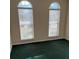 Bedroom featuring two large windows and green carpet at 8522 Long Meadow Dr, Charleston, SC 29420