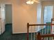 Upstairs hallway with neutral walls and green carpet at 8522 Long Meadow Dr, Charleston, SC 29420