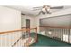 Hallway with wood and white railing overlooking a green carpeted room at 8522 Long Meadow Dr, Charleston, SC 29420