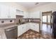 Kitchen boasts stainless steel appliances, white cabinetry, granite countertops, and tiled floors at 8522 Long Meadow Dr, Charleston, SC 29420
