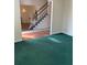Spacious living room with green carpet and stairway at 8522 Long Meadow Dr, Charleston, SC 29420