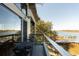 This balcony has chairs, table, and a view of the river and pool at 905 Palm Blvd, Isle of Palms, SC 29451