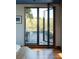 A bedroom with a view of the balcony. The balcony is complete with patio furniture for outdoor lounging at 905 Palm Blvd, Isle of Palms, SC 29451