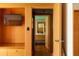 Bright bathroom features a wooden cabinet, mirror, and a view into an adjacent living space with a wall-mounted television at 905 Palm Blvd, Isle of Palms, SC 29451