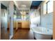 Bright bathroom featuring hardwood floors, mosaic tiled walls, and a standalone tub at 905 Palm Blvd, Isle of Palms, SC 29451