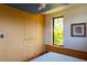 Comfortable bedroom boasting built-in storage and sun-drenched window with leafy views at 905 Palm Blvd, Isle of Palms, SC 29451