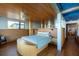 A modern bedroom with a wood ceiling, stylish bed, and blue accents creating a serene and inviting space at 905 Palm Blvd, Isle of Palms, SC 29451