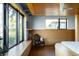 Bright bedroom featuring a large window seat, a patterned chair, and natural light enhancing its appeal at 905 Palm Blvd, Isle of Palms, SC 29451