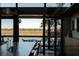Bright dining room with wood table and views of the water and marsh at 905 Palm Blvd, Isle of Palms, SC 29451